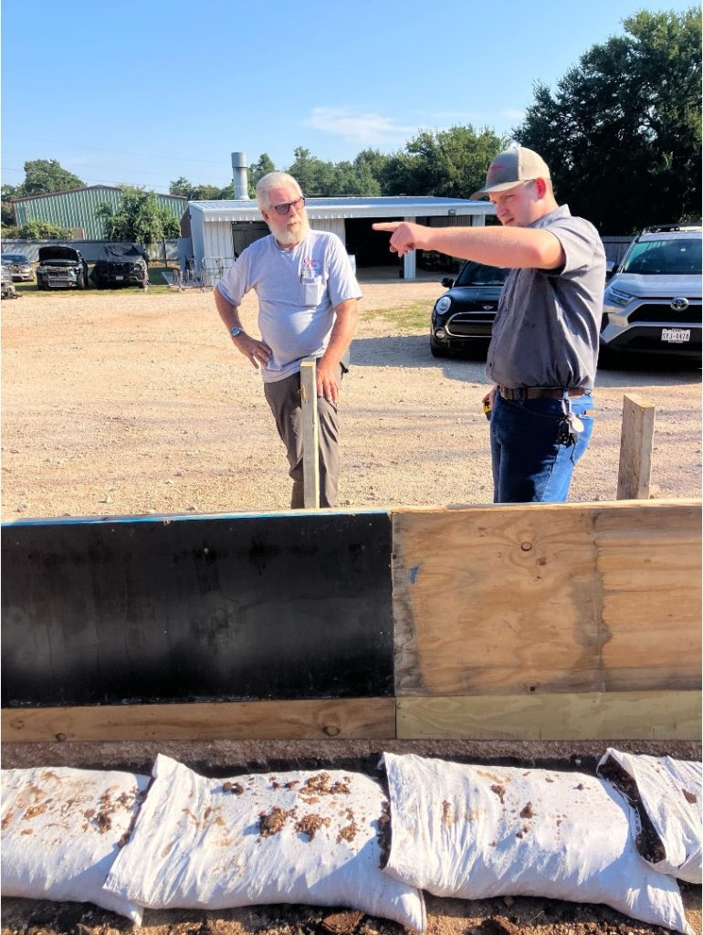 Complete Care Plumbing Electric & AC team members discussing a residential plumbing and construction project at an outdoor job site