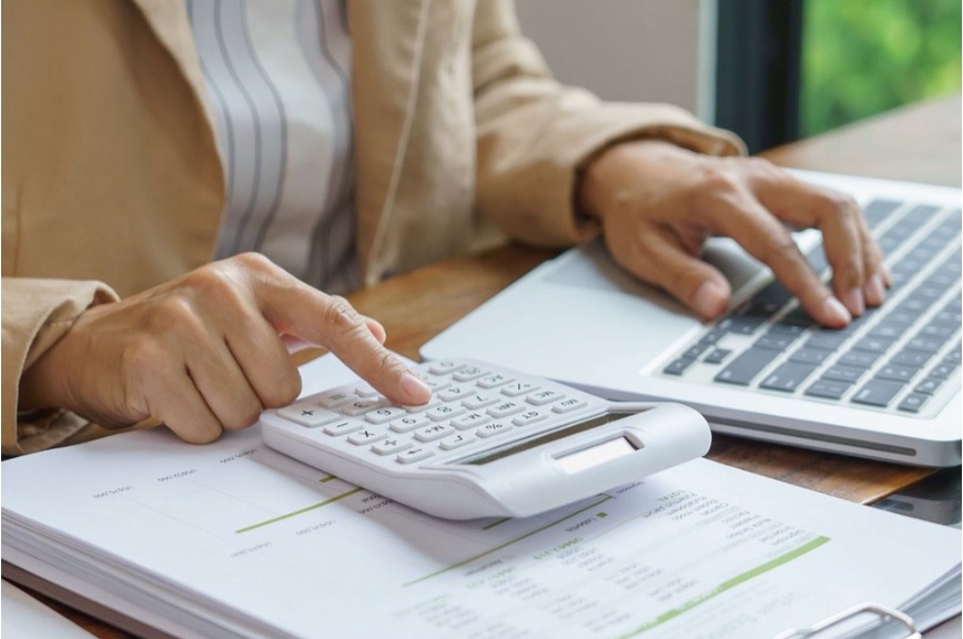 A business professional going over their financial records in preparation for a business sale.