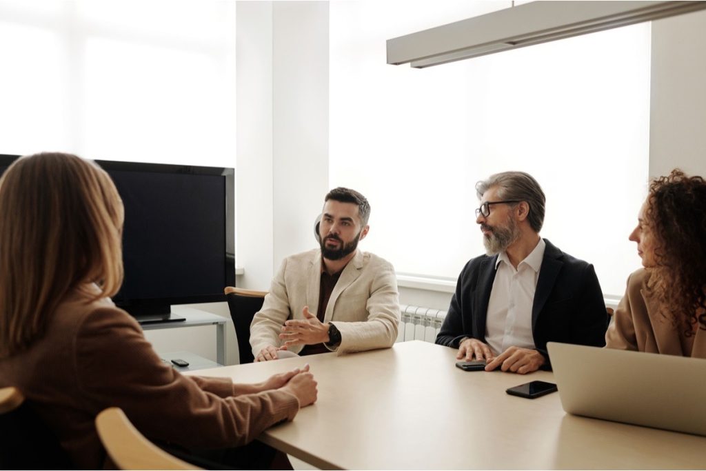 A group of professionals discussing seller financing terms
