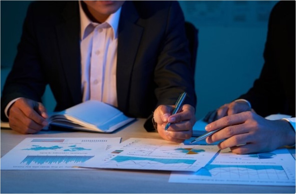 Business professional reviewing financial charts and graphs at a desk